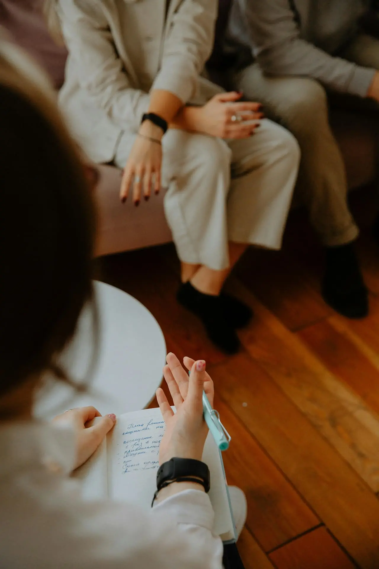 Psychoterapeutka robiąca notatki podczas sesji – zdjęcie ilustrujące wsparcie w pracy z trudnościami emocjonalnymi, lękiem, depresją i problemami w relacjach.